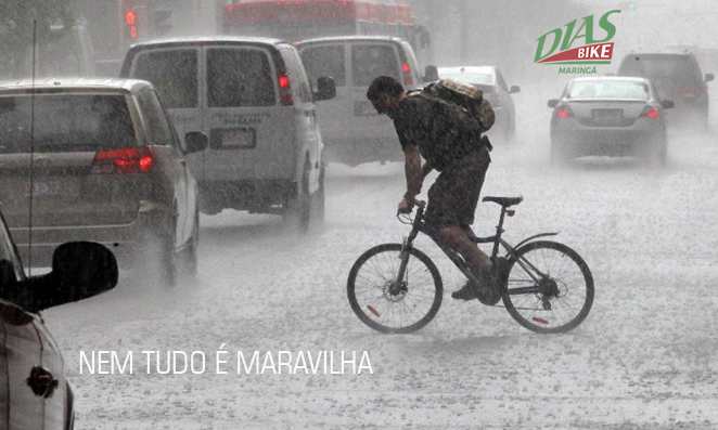 Homem pedalando na chuva forte no trânsito