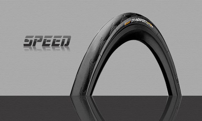 Pneu de bicicleta com fundo cinza e palavra speed escrito em preto