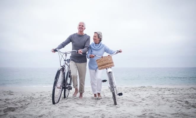 06 Casal de idosos com bicicleta na praia